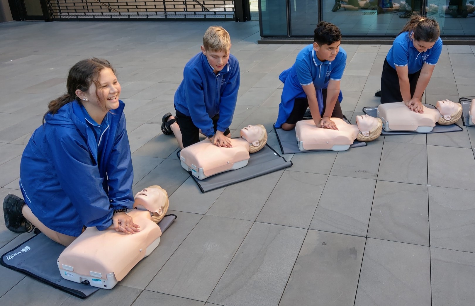 primary school children learning about cpr and breathing