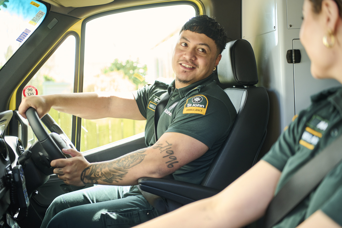 Two paramedics in the front of an ambulance