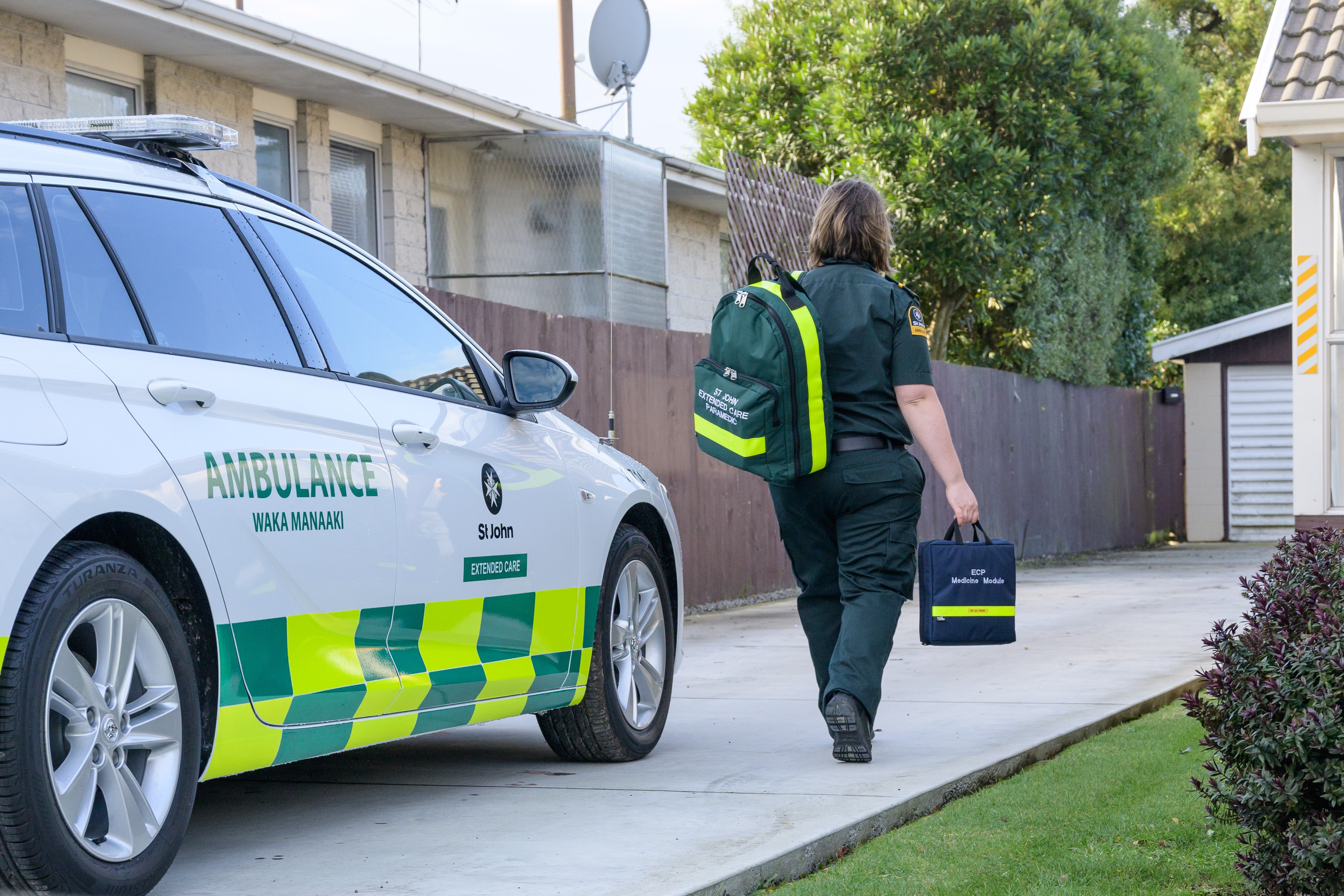 Paramedic approaching house with backpack