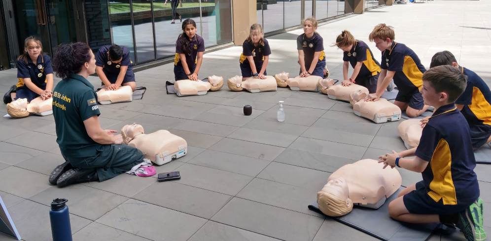 Students practising CPR with a tutor