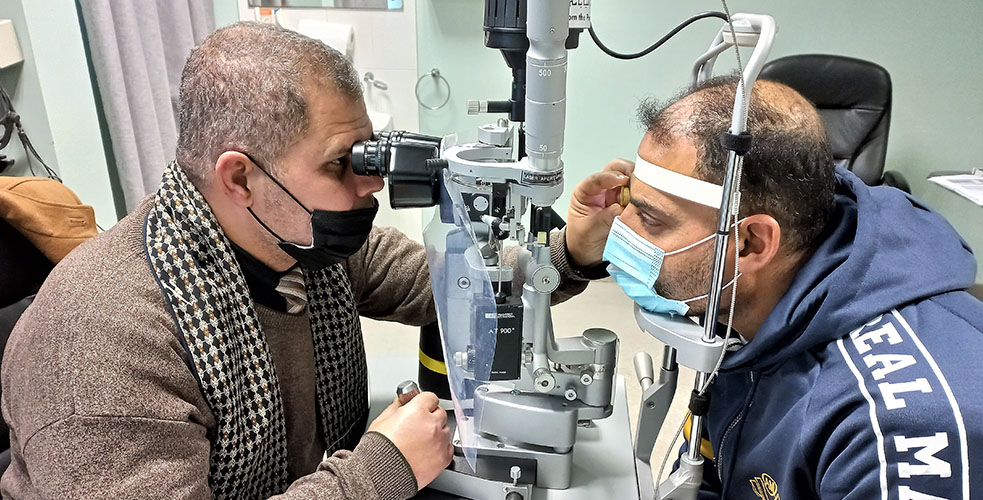 St John eye hospital doctor with patient