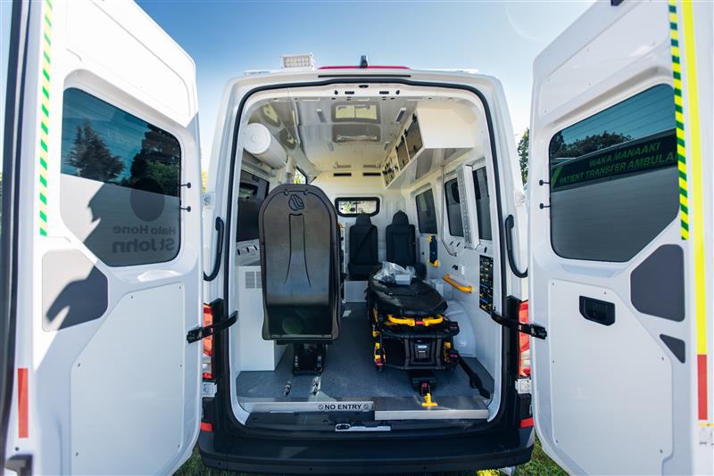 2 paramedics smiling outside of ambulance