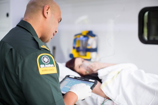 Ambulance officer treating patient