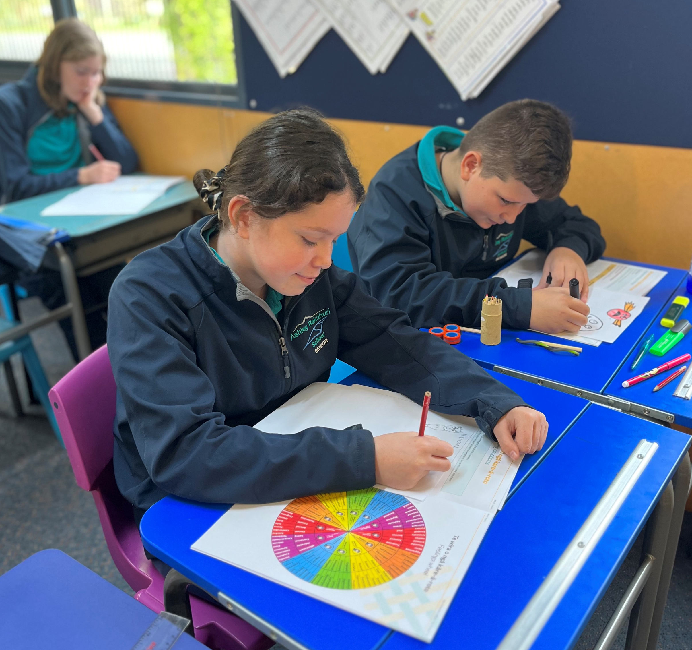 Young student reading the feelings wheel