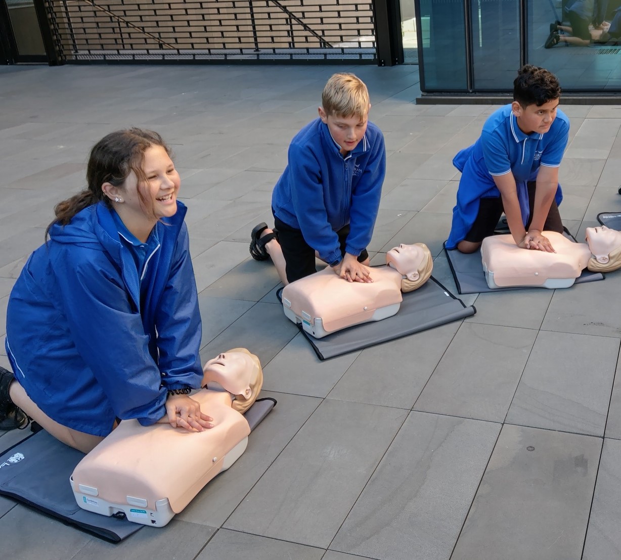 Students learning CPR on mannequins