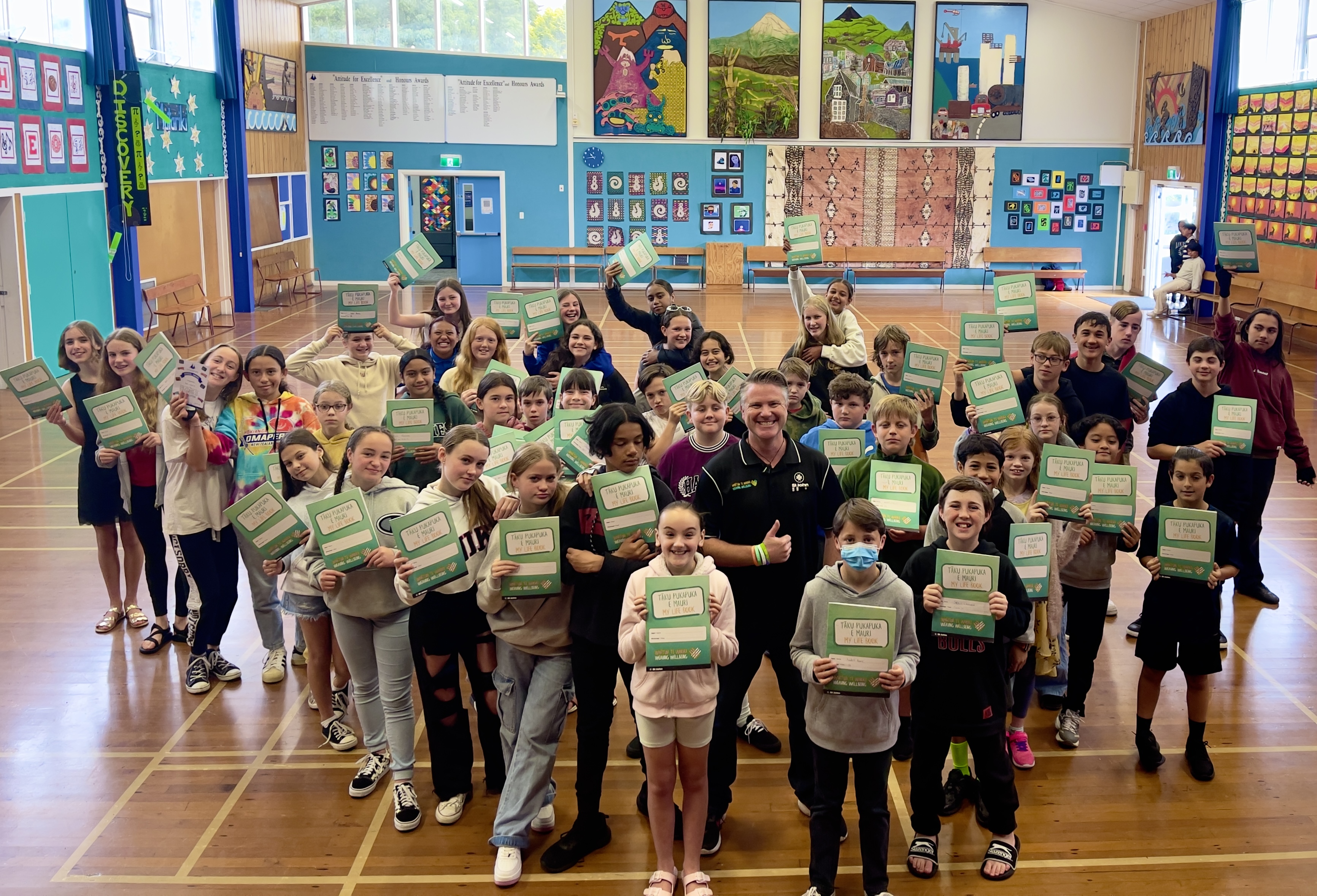 educator with primary school children holding their certificates