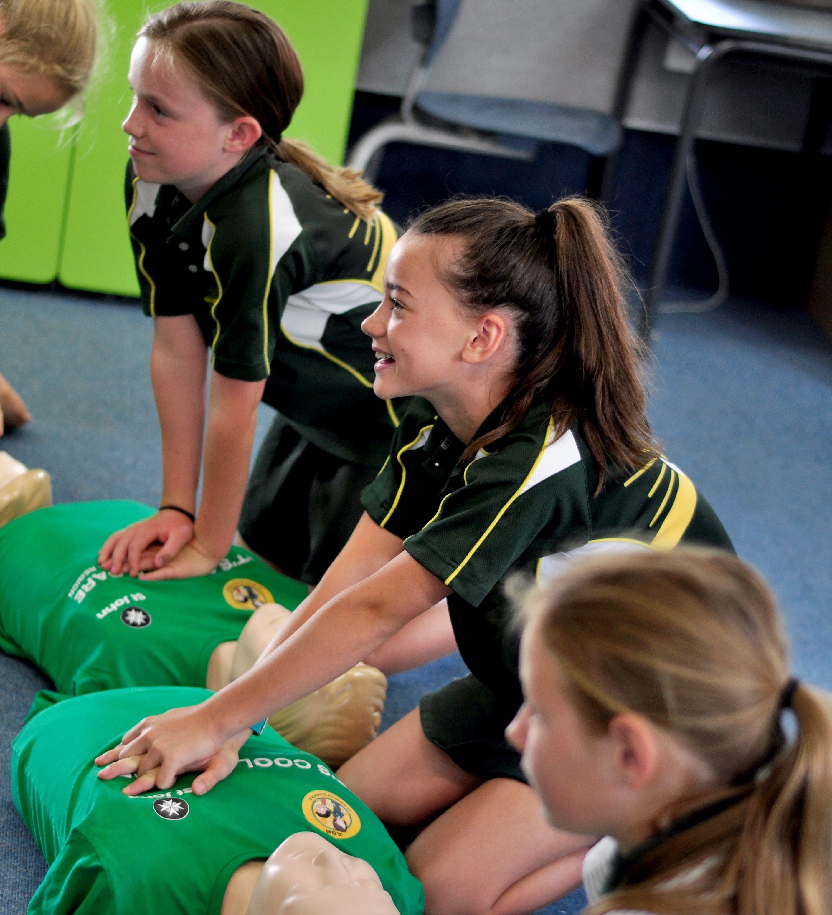 Students and ambulance officer carrying a student on a stretcher